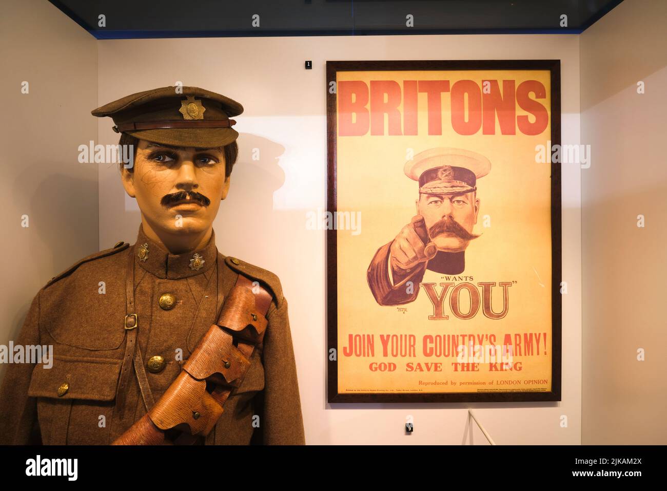 Display of an officer uniform and a British military recruiting poster. In the Museum of 1st The Queen’s Dragoon Guards and The Royal Welsh at Cardiff Stock Photo