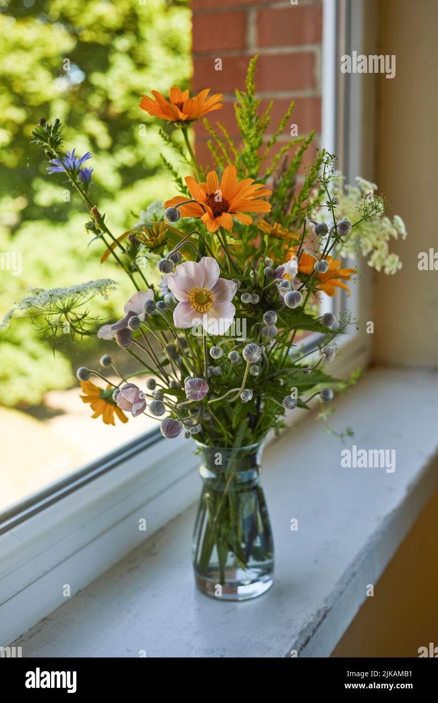 Beautiful bouquet of wildflowers isolated on windowsill. Stock Photo