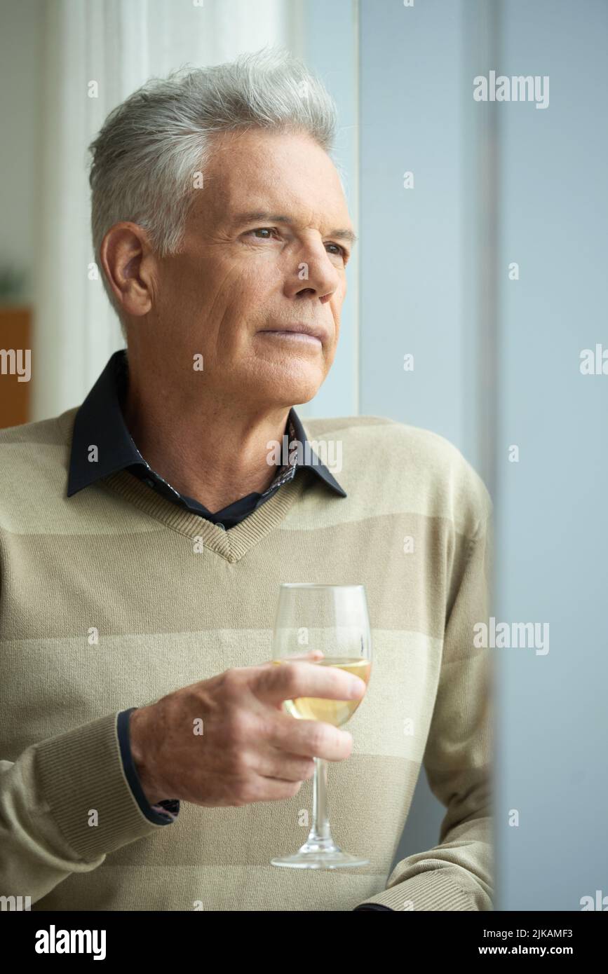 Pensive mature handsome man with a glass of wine Stock Photo
