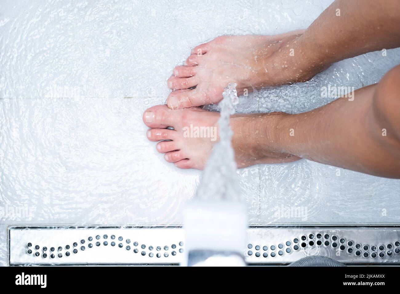 Woman washing feet, close up. Female stands under shower water Stock Photo Alamy