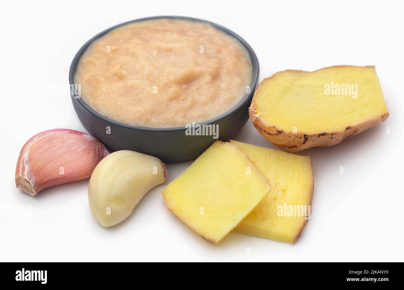 Ginger and garlic with paste over white background Stock Photo