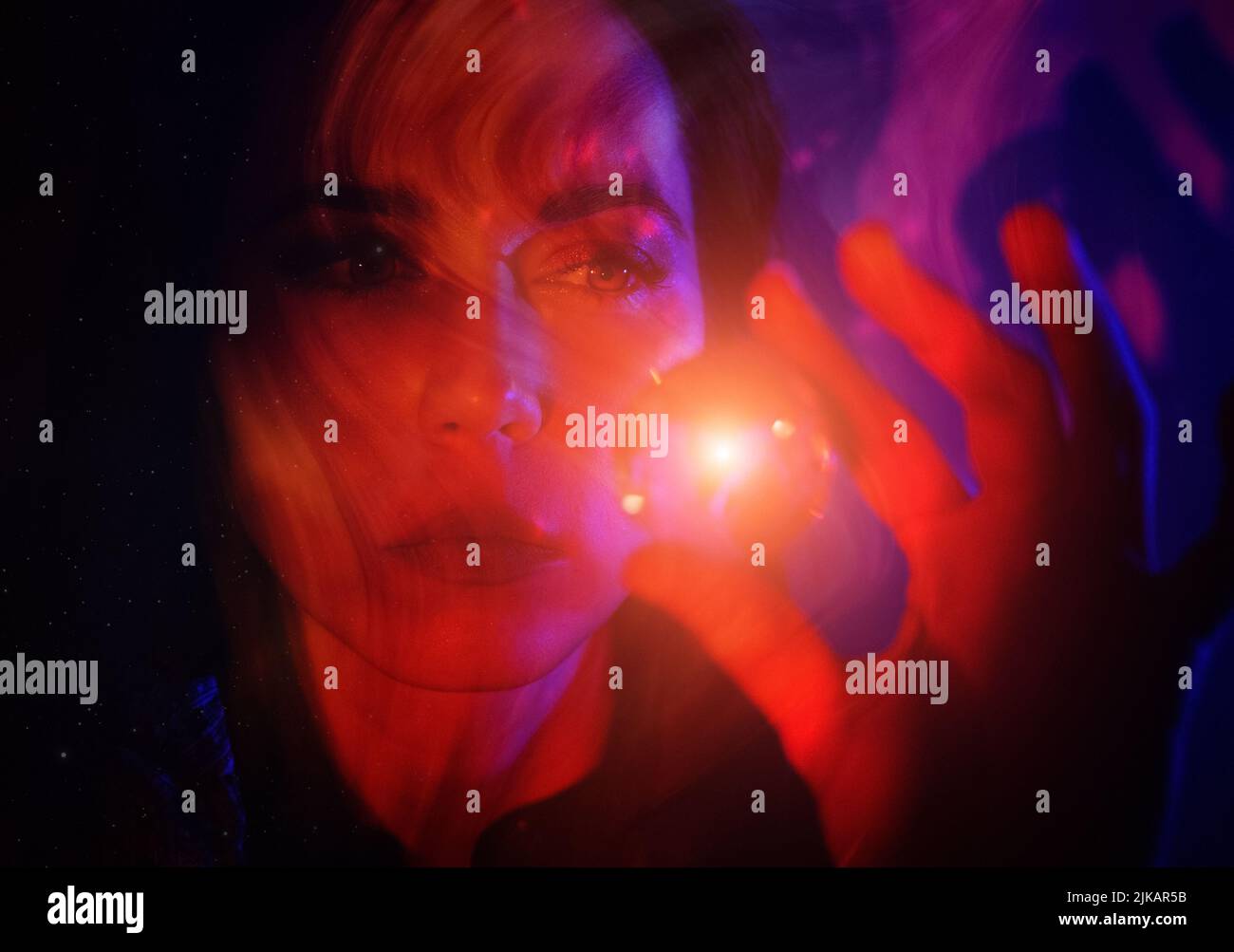 Young woman looking into crystal ball Stock Photo Alamy