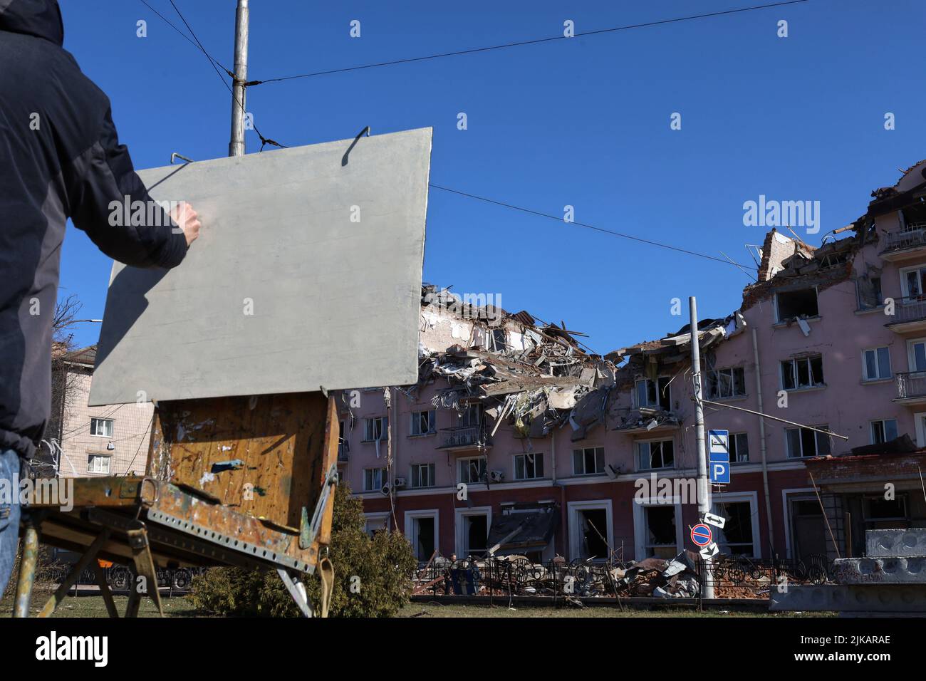 The artist draws a destroyed building, the war in Ukraine Stock Photo