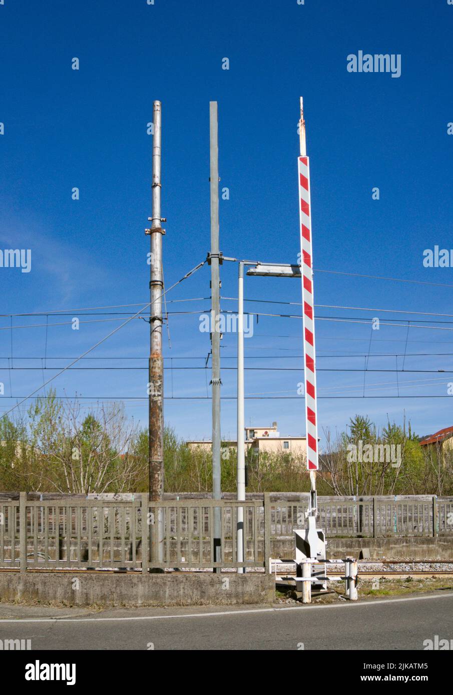 level crossing barrier up and power poles Stock Photo