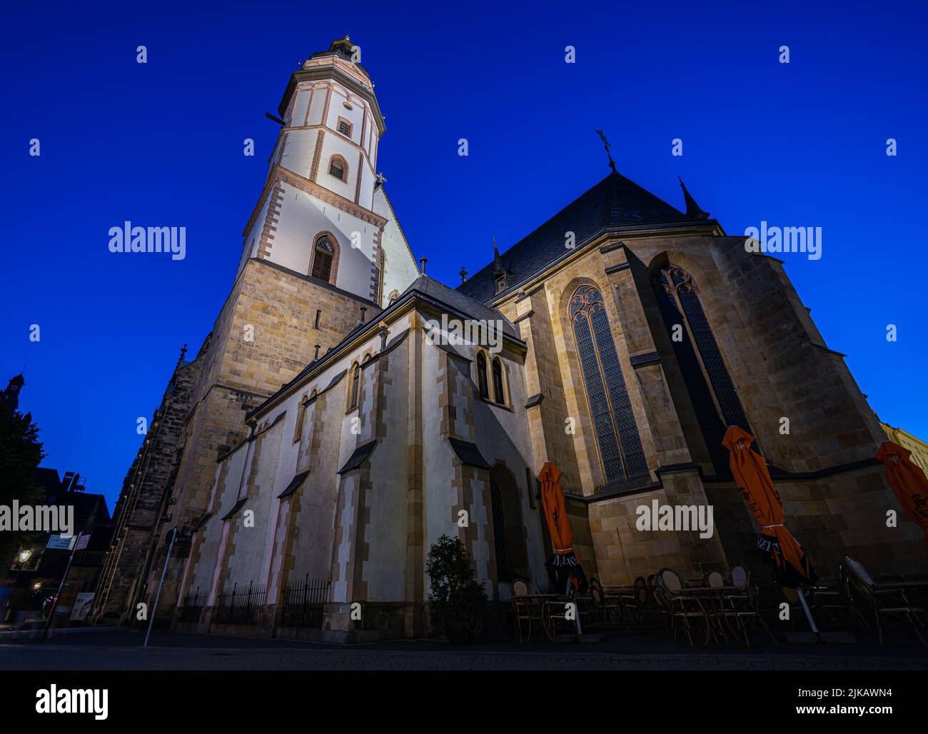Leipzig, Germany - July 02, 2022: The city Center of the saxony metropolis at night. The Thomaskirche or St. Thomas Church illuminated under clear dar Stock Photo