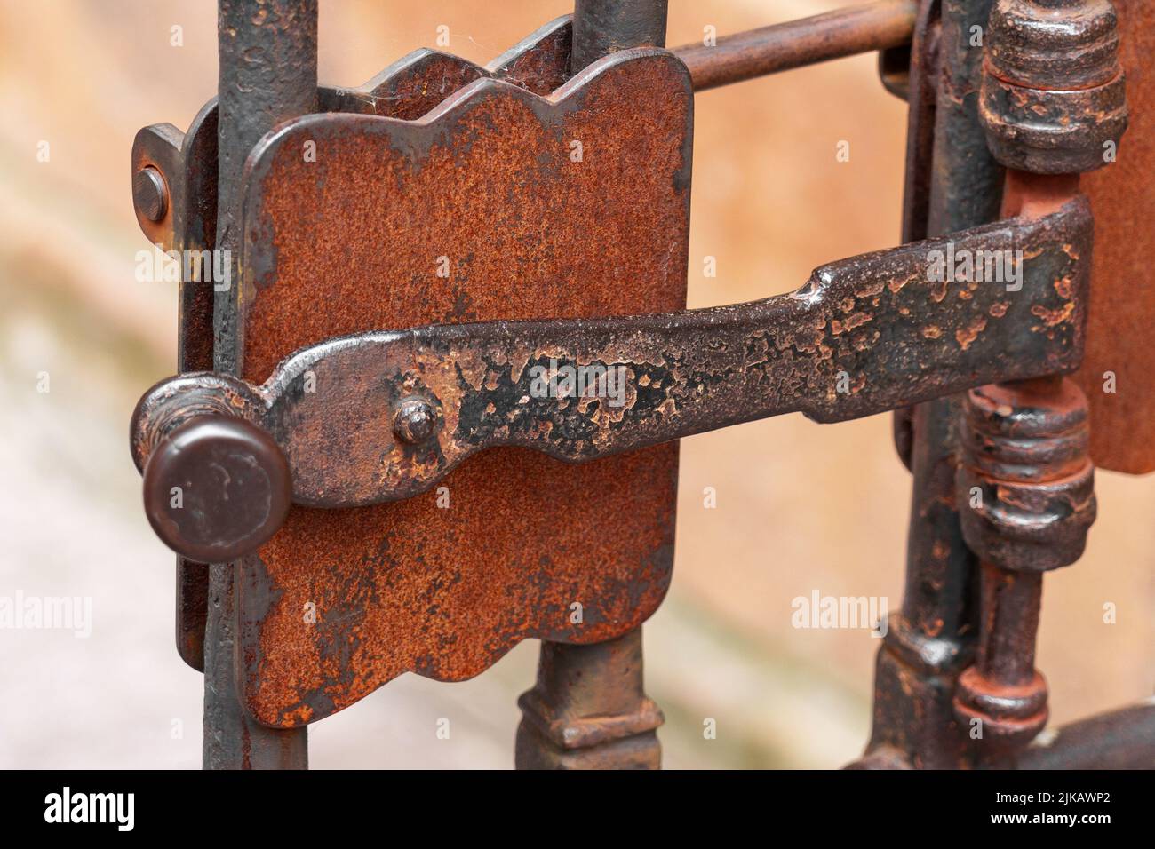 Ancient metal rusty wrought handle deadbolt (latch) of closed door of