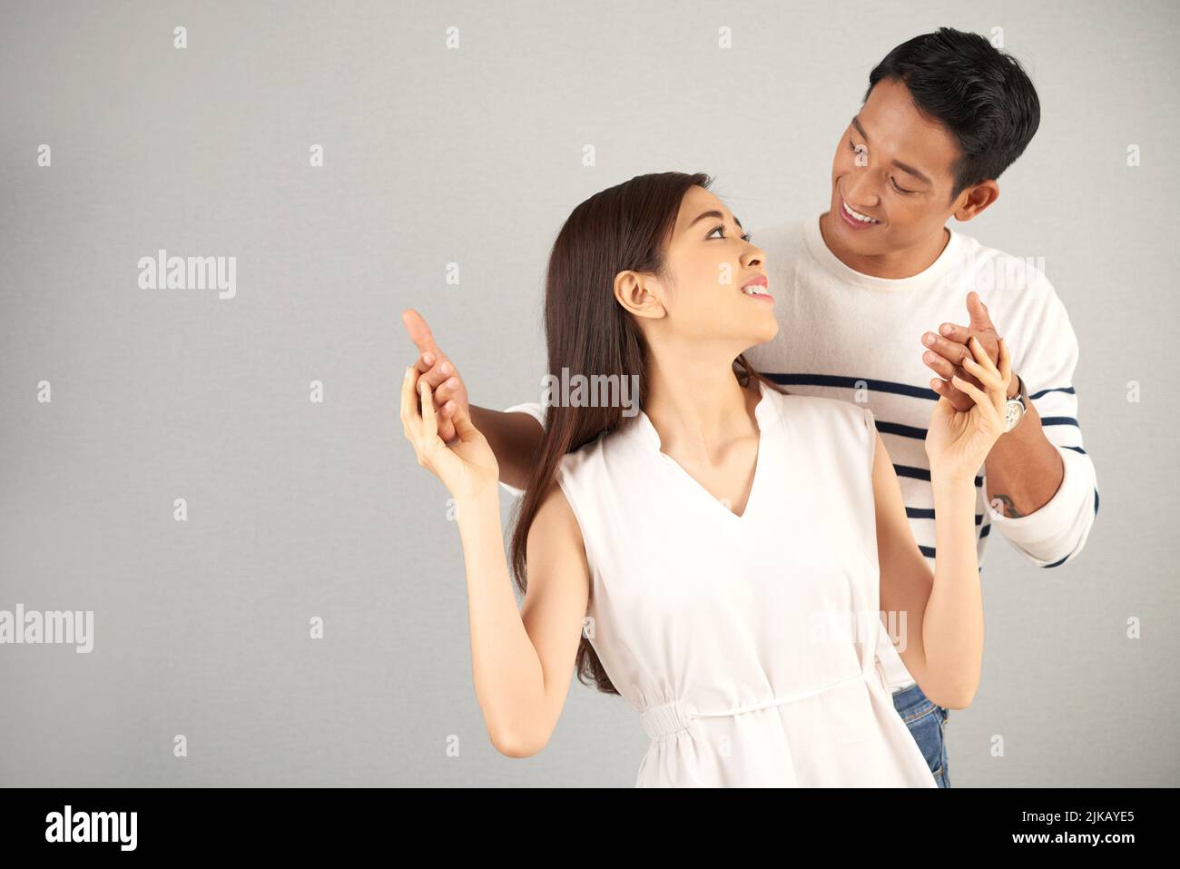 Happy young woman and her loving boyfriend looking affectionately at each other Stock Photo
