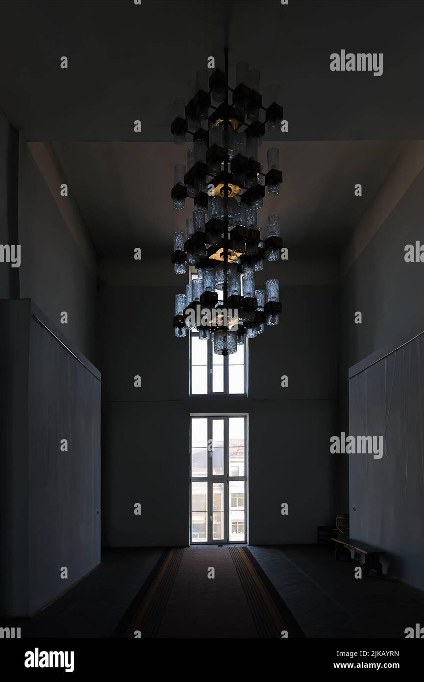 Dark room with big chandelier Stock Photo Alamy