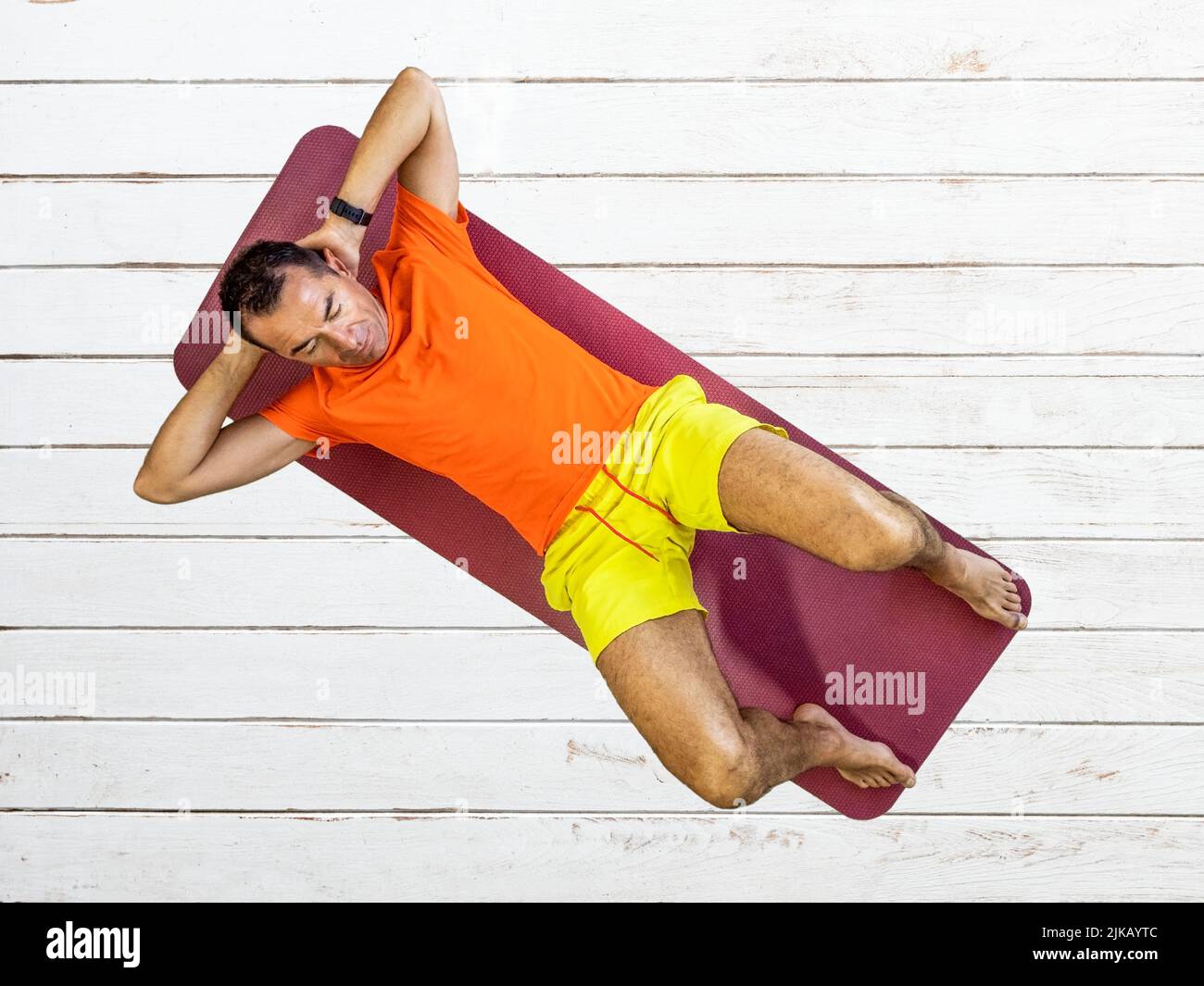 gymnastics, a man exercises his abdominal muscles on a mat, home