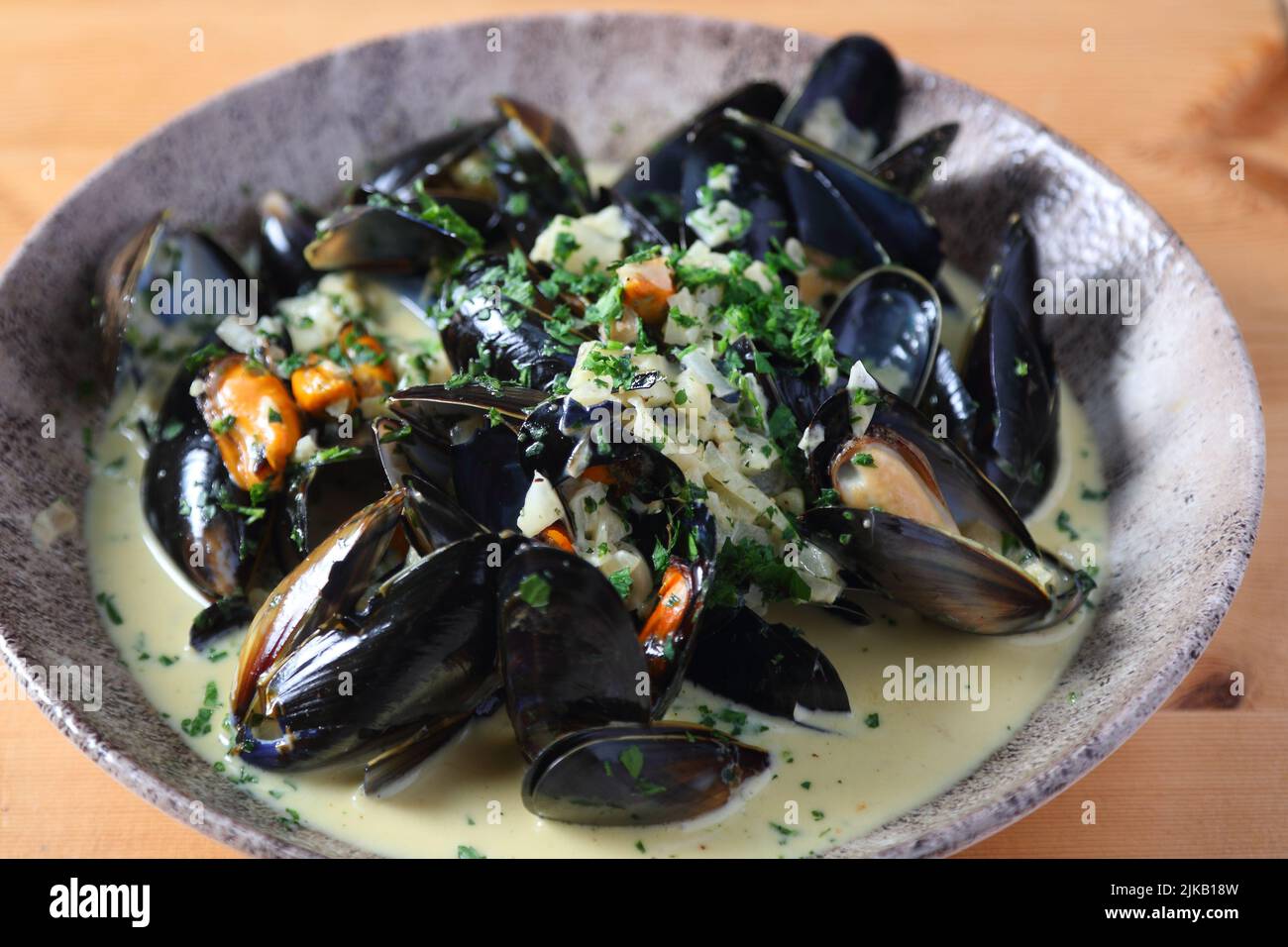 Cooked mussels in a cream sauce presented in a dish Stock Photo Alamy