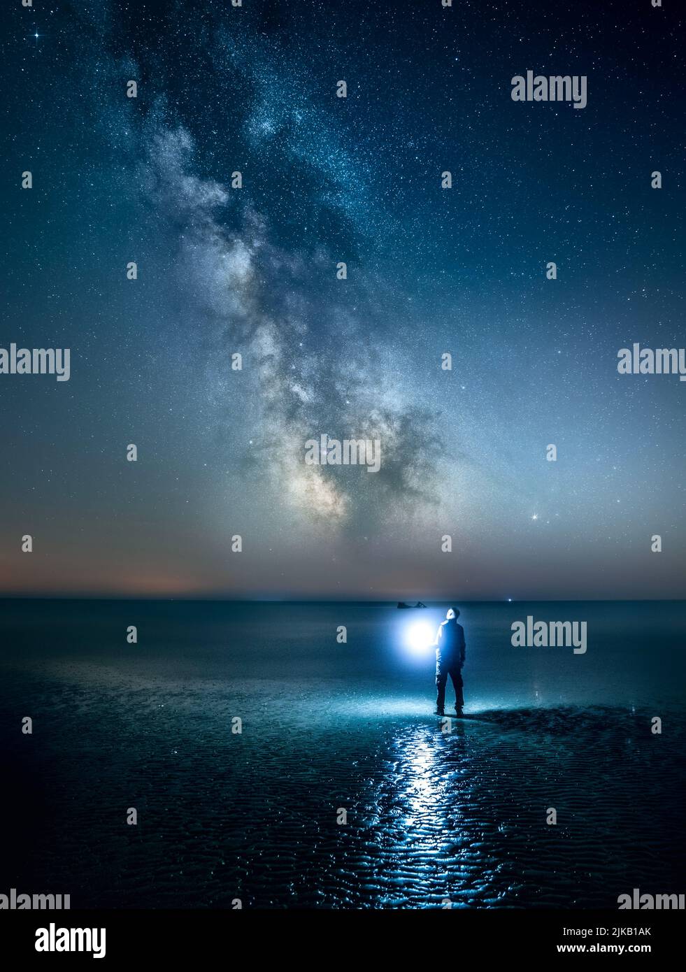 A stunning image titled 'Stargazing, Stargazer'. UK: THESE STUNNING images of a lone traveller crossing incredible landscapes prove how the UK is one Stock Photo