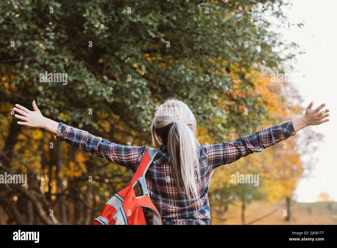 hiking journey lady backpack autumn forest scene Stock Photo Alamy