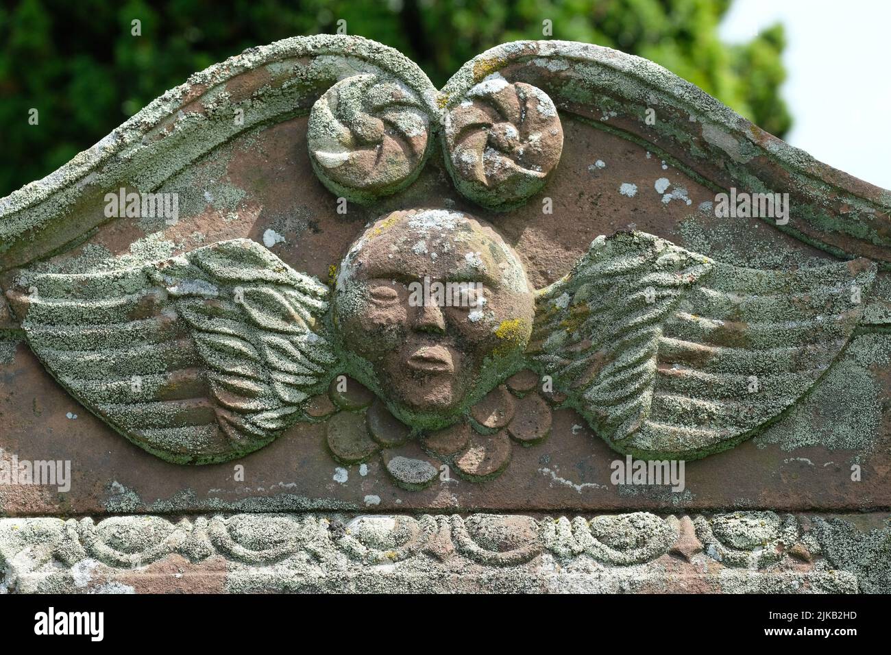 Winged angel design on a 18th century gravestone at Kirkandrews burial ground in Dumfries and Galloway Scotland Stock Photo