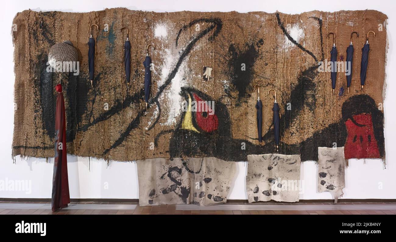 Joan Miró/ Sobreteixim de los ocho paraguas, 1973. Acrílico y objetos sobre «sobreteixim» hecho a mano por Josep Royo. 312 x 593 x 40 cm. Museum: FUNDACIO JOAN MIRO, Barcelona, SPAIN. Stock Photo