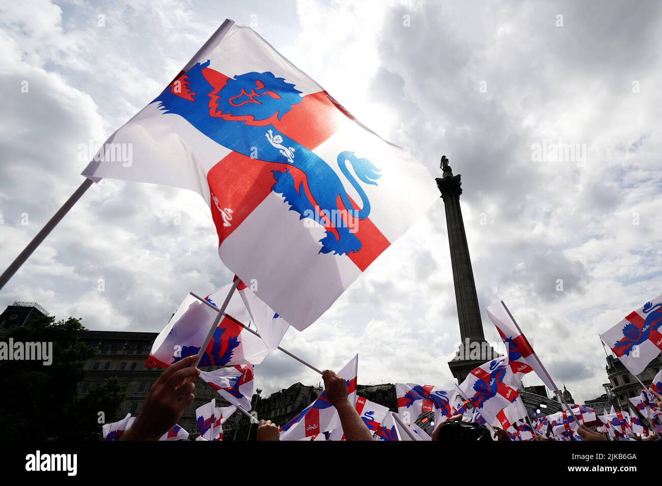 Fans wave St Georges flags during a fan celebration to commemorate England's historic UEFA Women's EURO 2022 triumph in Trafalgar Square, London. Picture date: Monday August 1, 2022. Stock Photo