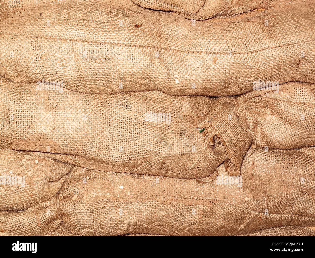 Sandbags background stacked in a heap for use as flood defence or for the military as a barricade, stock photo image Stock Photo