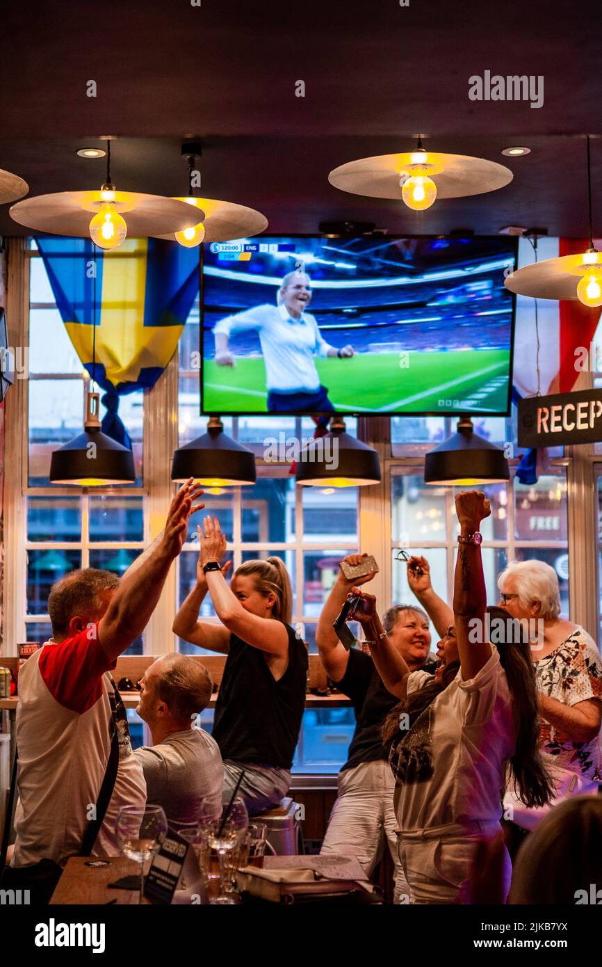 Viewers in Belushi's Sports Bar, Bath, England, celebrate the fulltime