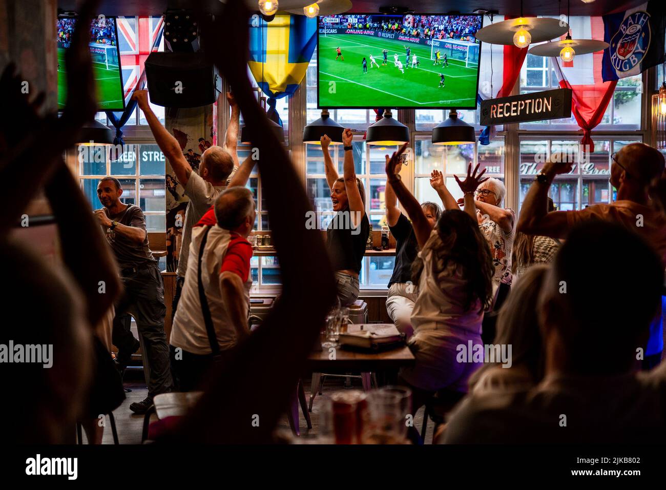Viewers in Belushi's Sports Bar, Bath, England, celebrate Chloe Kelly's