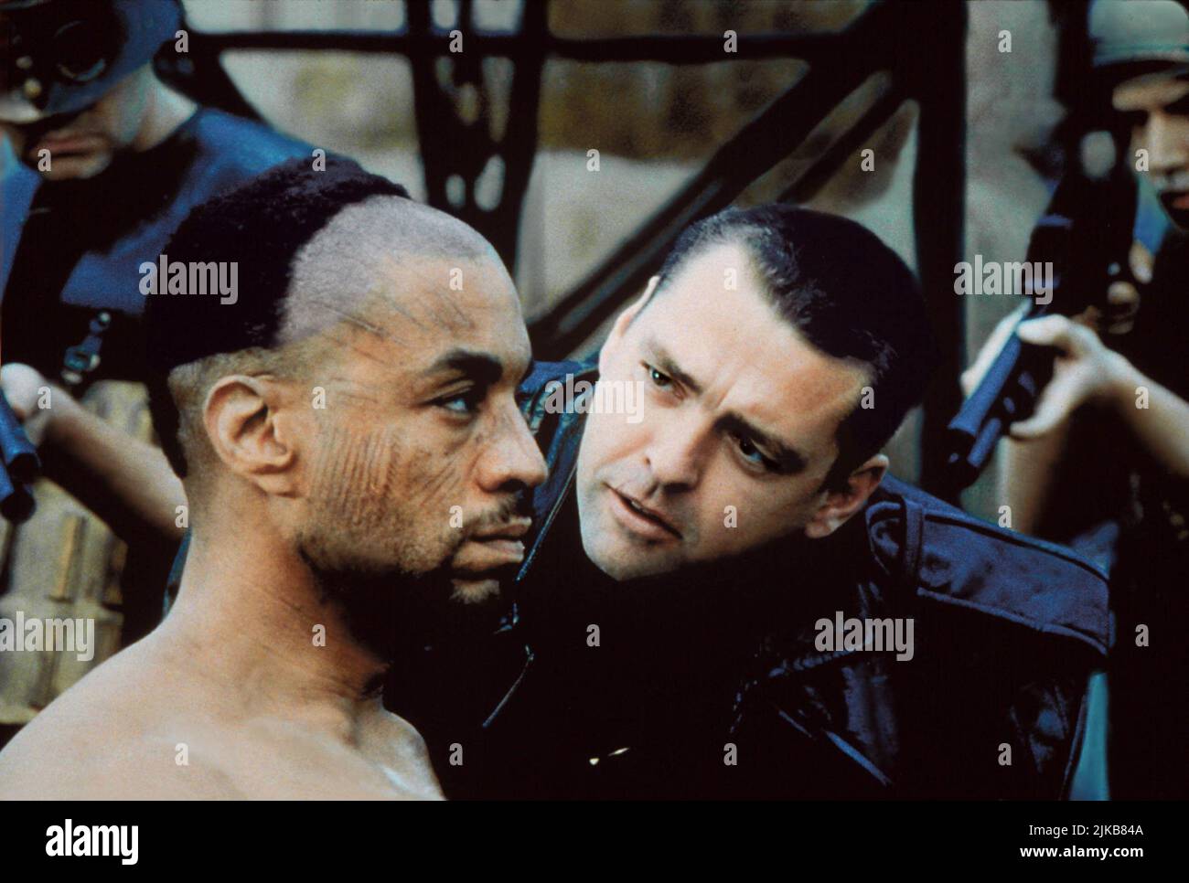 Harry Lennix & Angus Macfadyen Film: Titus (1999) Characters: Aaron & Lucius  Director: Julie Taymor 25 December 1999   **WARNING** This Photograph is for editorial use only and is the copyright of FOX SEARCHLIGHT and/or the Photographer assigned by the Film or Production Company and can only be reproduced by publications in conjunction with the promotion of the above Film. A Mandatory Credit To FOX SEARCHLIGHT is required. The Photographer should also be credited when known. No commercial use can be granted without written authority from the Film Company. Stock Photo