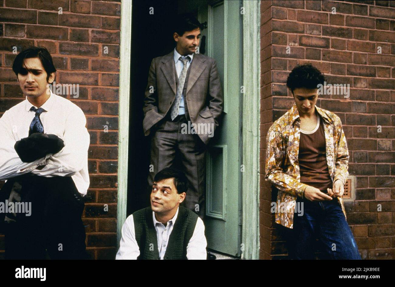 Raji James, Chris Bisson, Jimi Mistry & Emil Marwa Film: East Is East (UK 1999) Characters: Abdul Khan,Saleem Khan,Tariq Khan & Maneer Khan  Director: Damien O'Donnell 14 May 1999   **WARNING** This Photograph is for editorial use only and is the copyright of FILMFOUR and/or the Photographer assigned by the Film or Production Company and can only be reproduced by publications in conjunction with the promotion of the above Film. A Mandatory Credit To FILMFOUR is required. The Photographer should also be credited when known. No commercial use can be granted without written authority from the Fil Stock Photo
