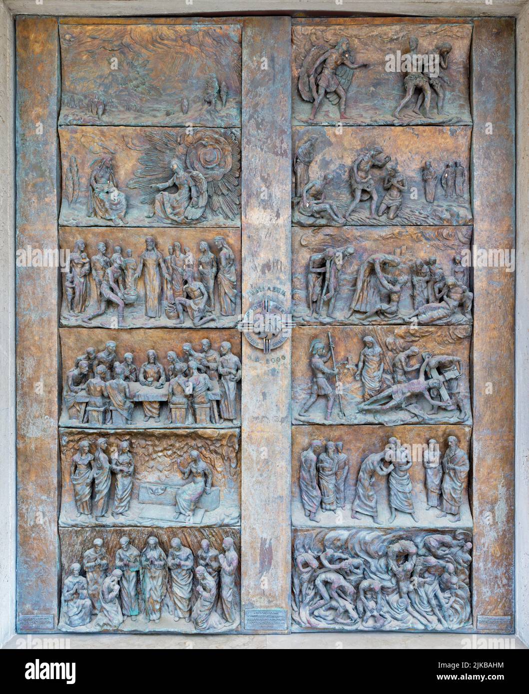 MONOPOLI, ITALY - MARCH 6, 2022: The bronze reliefs  on the gate of church Chiesa di Sacro Cuore by Wolfgang Stempfele from year 2002. Stock Photo