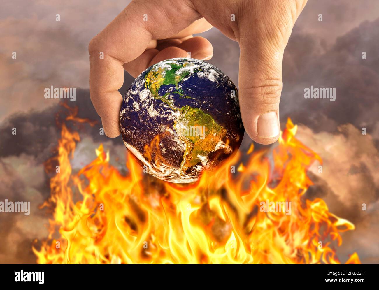 Human holding earth on fire, global warming conce Stock Photo