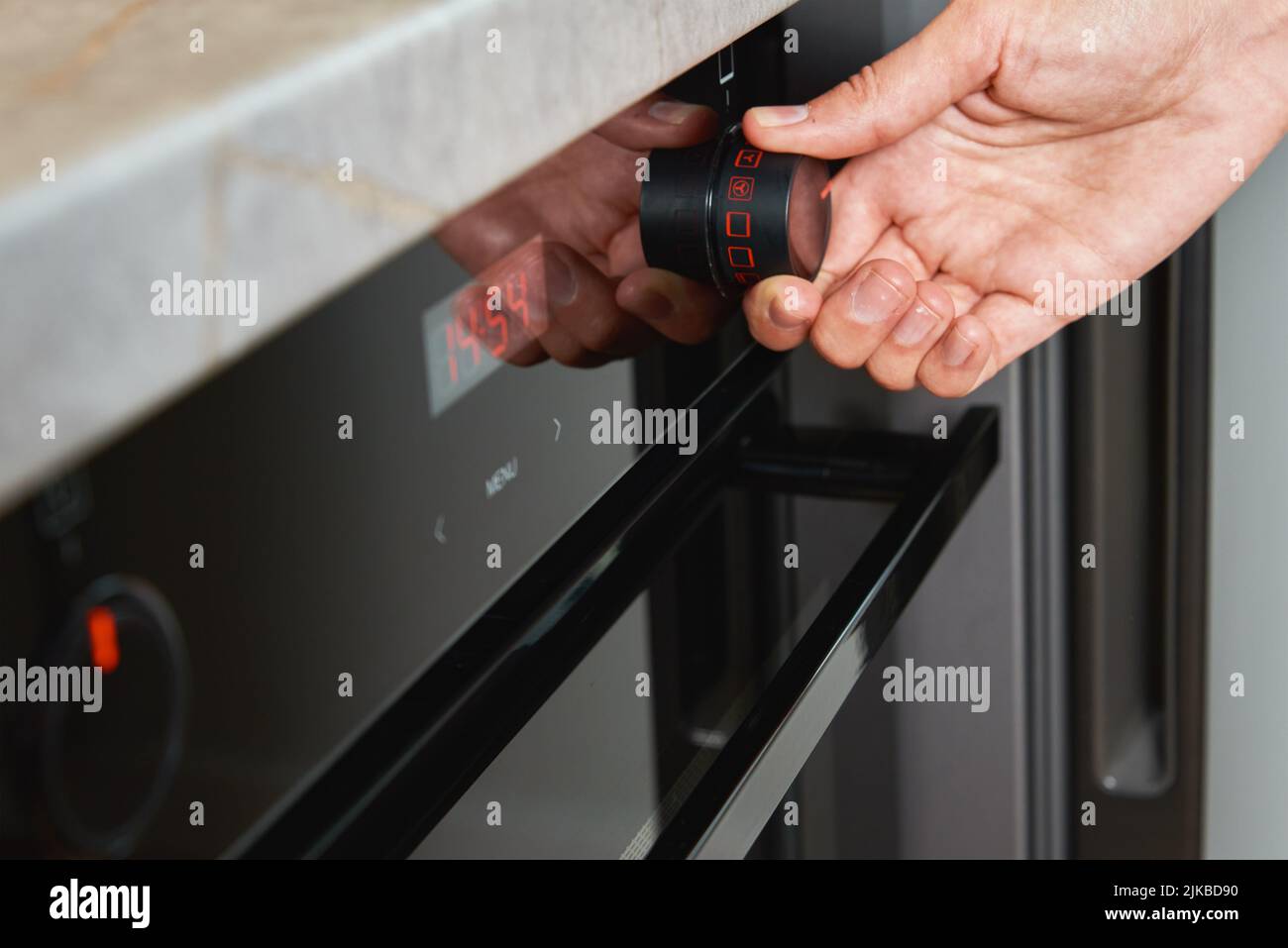 Female hand choose baking program on electric oven control panel, Woman