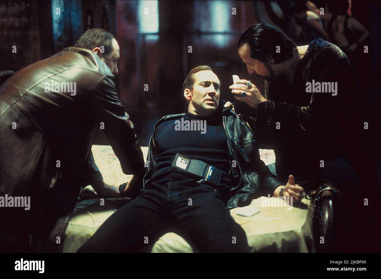 James Gandolfi, Nicolas Cage & Peter Stormare Film: 8mm (USA/DE 1999) Characters: ,Tom Welles & Dino Velvet  Director: Joel Schumacher 19 February 1999   **WARNING** This Photograph is for editorial use only and is the copyright of COLUMBIA PICTURES and/or the Photographer assigned by the Film or Production Company and can only be reproduced by publications in conjunction with the promotion of the above Film. A Mandatory Credit To COLUMBIA PICTURES is required. The Photographer should also be credited when known. No commercial use can be granted without written authority from the Film Company. Stock Photo