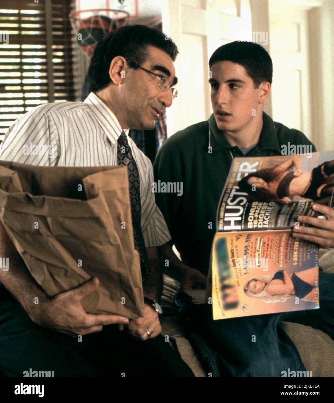 Eugene Levy & Jason Biggs Film: American Pie (1999) Characters: Jim's Dad & Jim Levenstein  Director: Paul Weitz 09 July 1999   **WARNING** This Photograph is for editorial use only and is the copyright of UNIVERSAL and/or the Photographer assigned by the Film or Production Company and can only be reproduced by publications in conjunction with the promotion of the above Film. A Mandatory Credit To UNIVERSAL is required. The Photographer should also be credited when known. No commercial use can be granted without written authority from the Film Company. Stock Photo