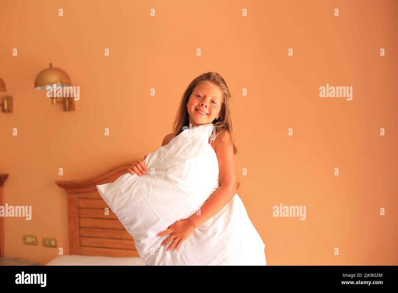 Pillow fight. A child with a pillow in his hands. The child is sleeping