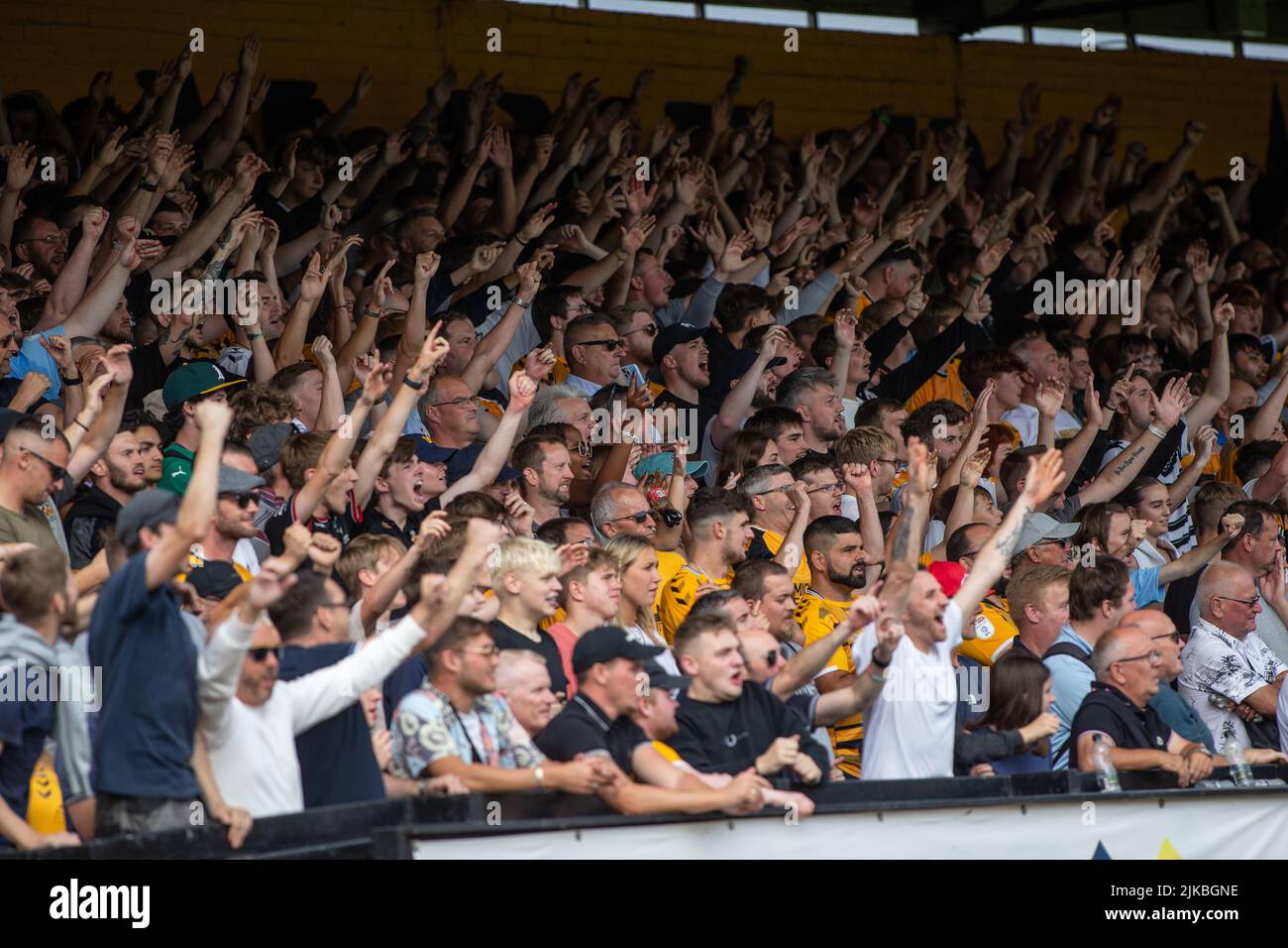 Football soccer fans cheering and chanting during match. Stock Photo