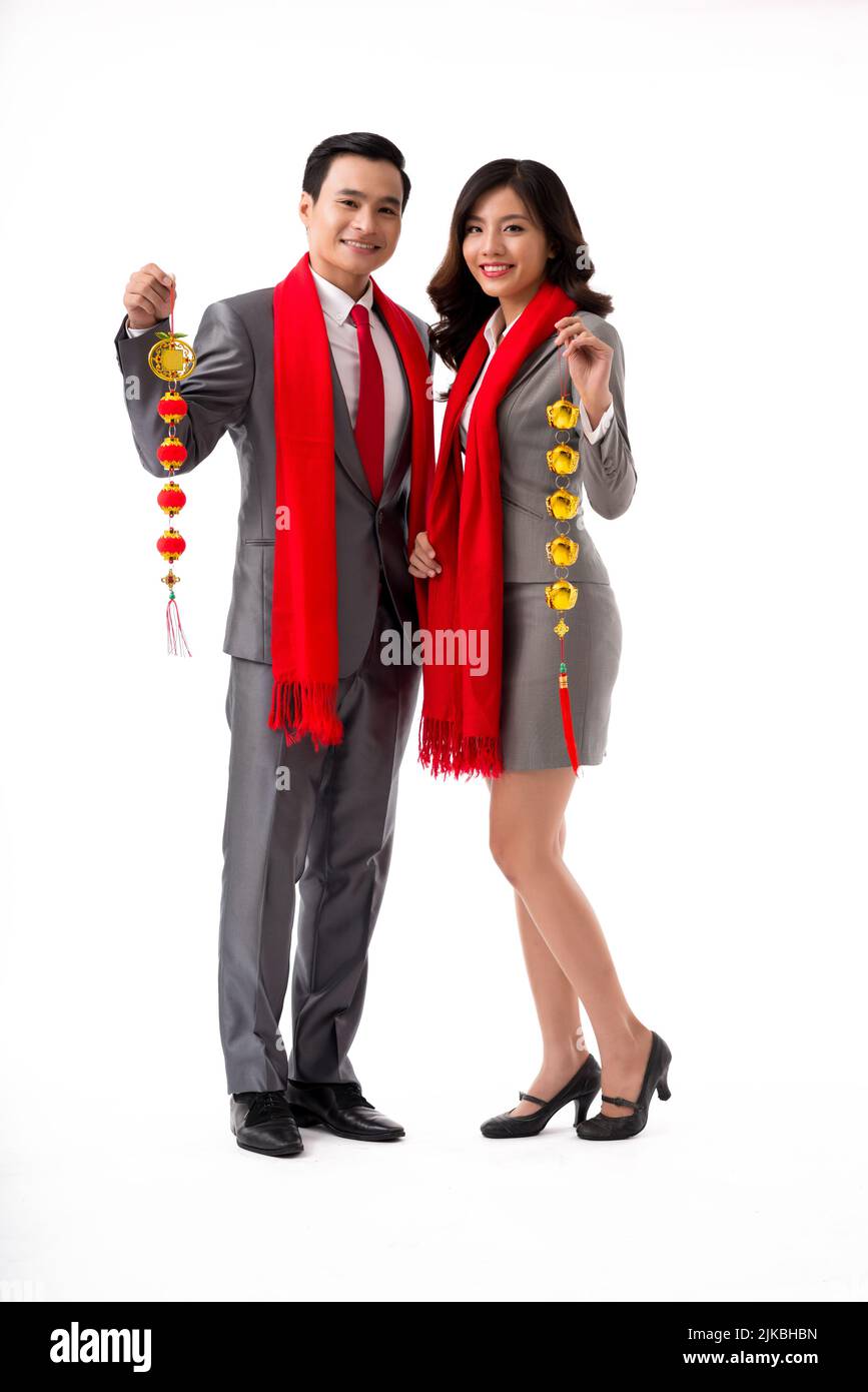 Studio portrait of VIetnamese couple with Tet decorations Stock Photo