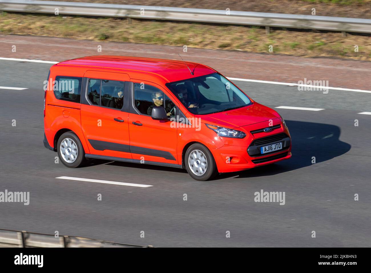 2016 red FORD TORNEO Connect 1499cc Diesel 6 speed manual People carrier, 5/7-seater and 5 doors front wheel drive car.;  travelling on the M6 Motorway, Manchester, UK Stock Photo