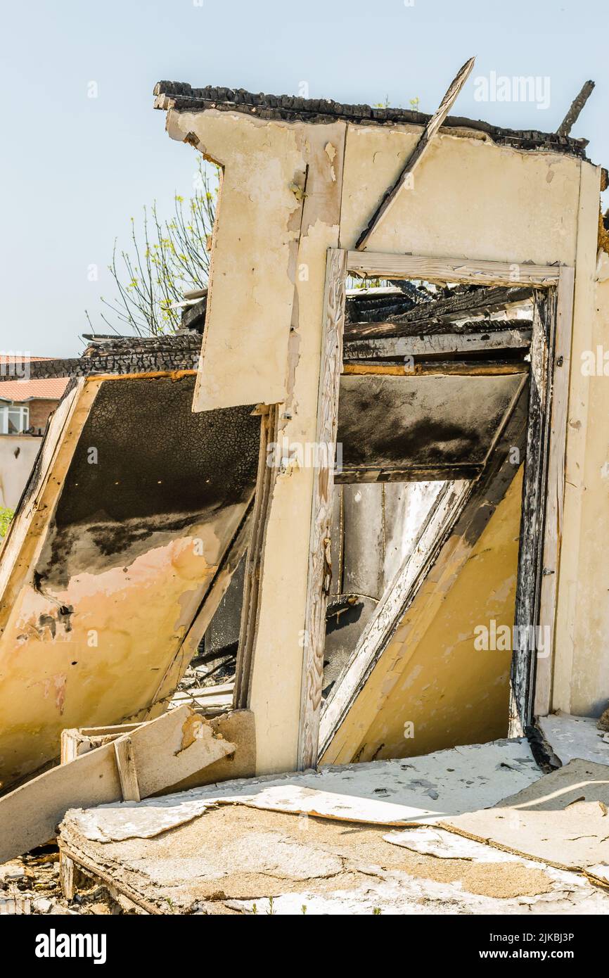 The remains of the burnt house. Ruined and collapsed house burnt and