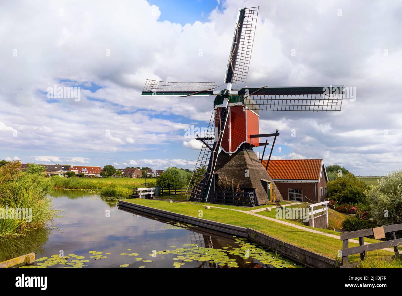 A historic drainage mill, called Vrouw Vennemolen, set in a typically Dutch polder landscape, Blauwe Polder, Oud-Ade, South Holland, The Netherlands. Stock Photo