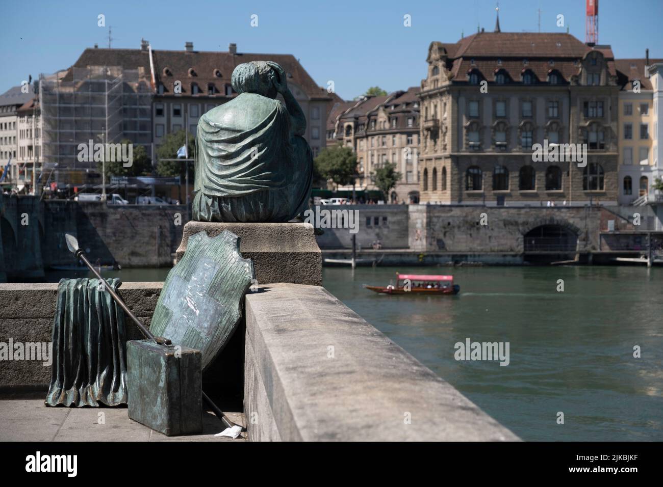 Helvetia bronze statue in gown, with a spear and a shield emblazoned with the Swiss flag looking out over the river Rhine in Basel, Switzerland Stock Photo