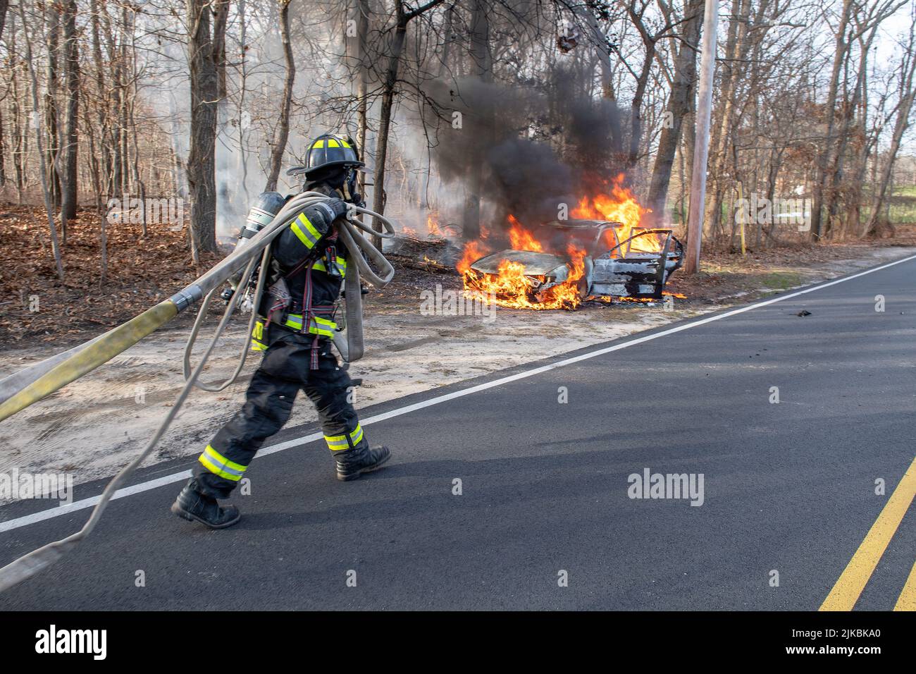 Members of the East Hampton Fire Department extinguish a working fire in an apparently abandoned vehicle in front of 404 Accabonac Road at 2:40 p.m. Stock Photo