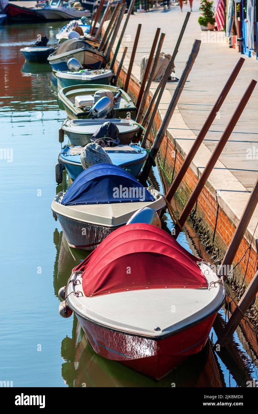 Boats waiting on a canal in Burano Stock Photo