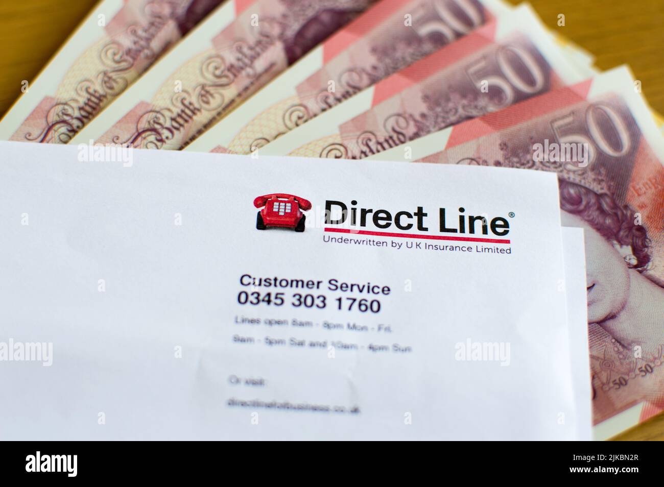 Directline Insurance and cash currency in background Stock Photo
