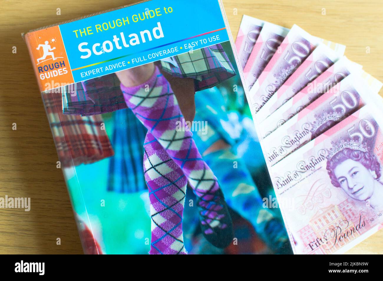 Rough guide to Scotland travel book and currency on a table Stock Photo