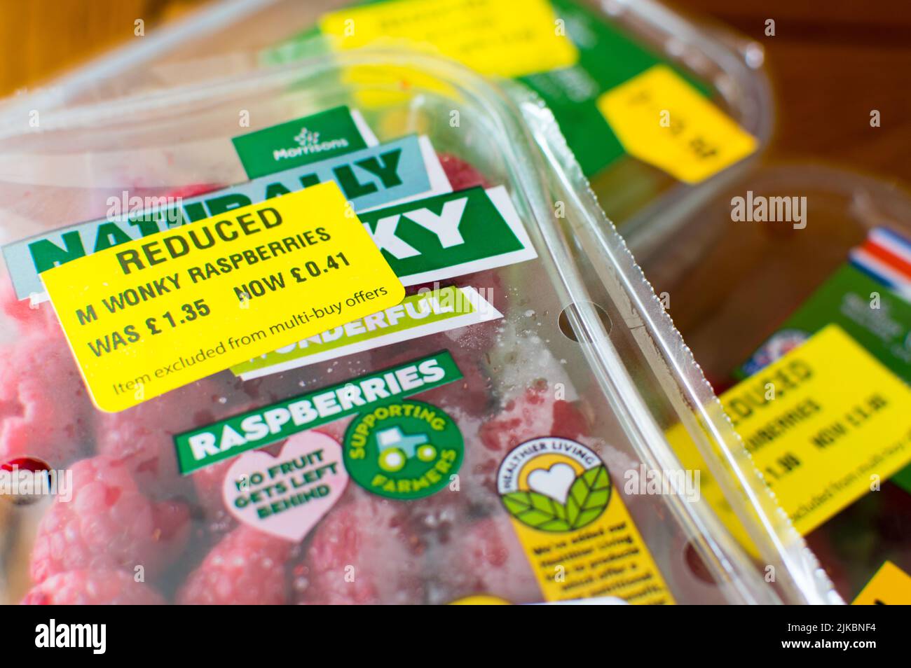 Yellow sticker labelled fruits in supermarket to reduce food waste Stock Photo