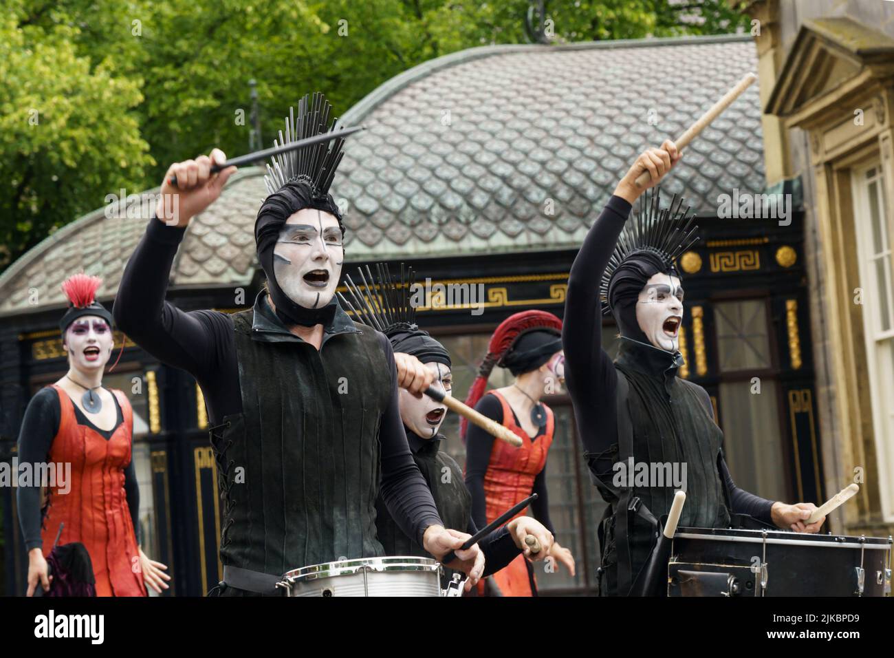 Drummers in black and white face paint performing on the street during the Harrogate Carnival Parade in North Yorkshire, England, UK. Stock Photo