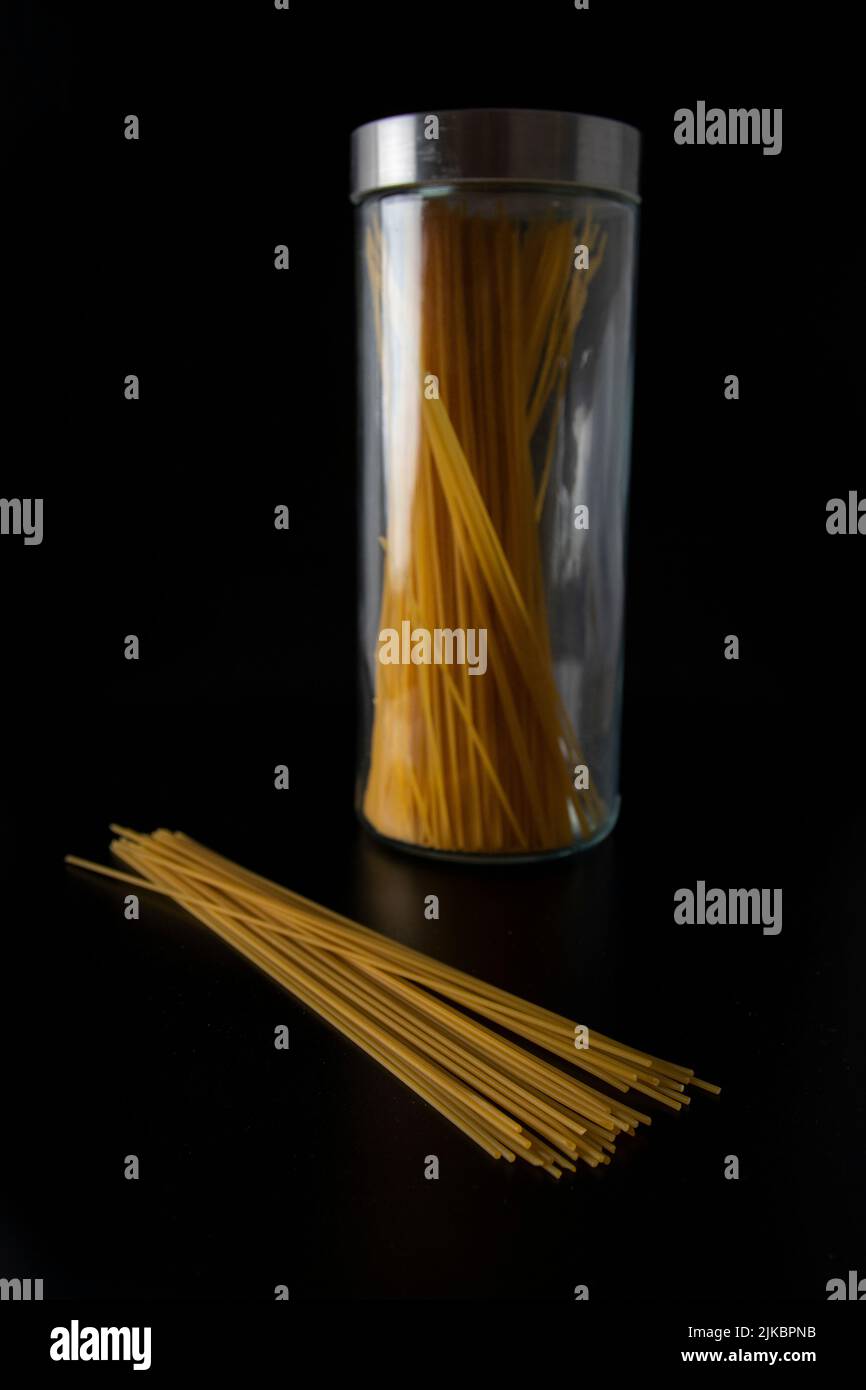 Spaghetti pasta in front of glass jar on the black background Stock Photo Alamy
