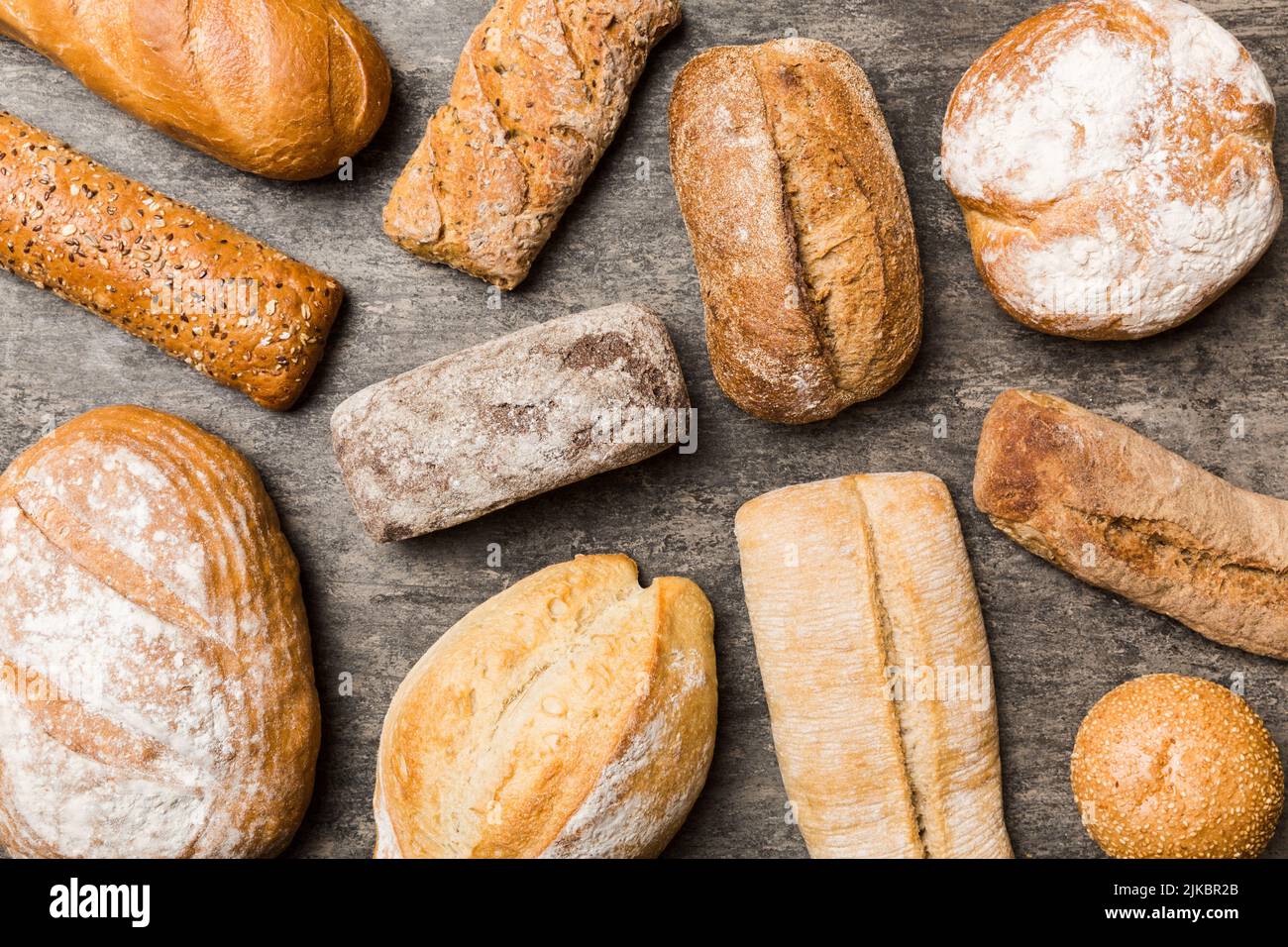 Homemade natural breads. Different kinds of fresh bread as background, top view with copy space