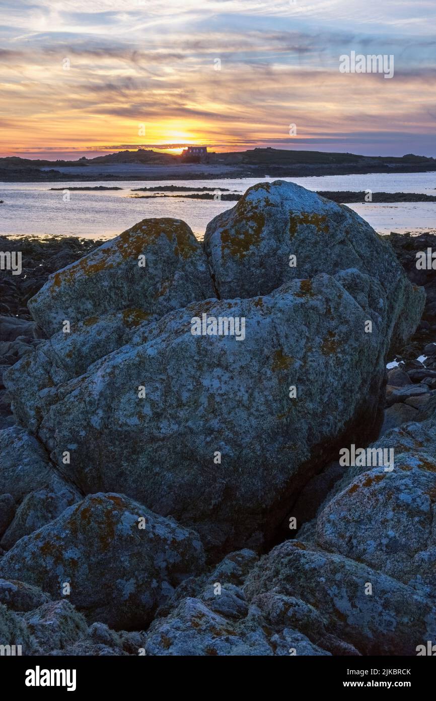 Sun setting over Lihou Island from L'Erée, Guernsey, Channel Islands Stock Photo