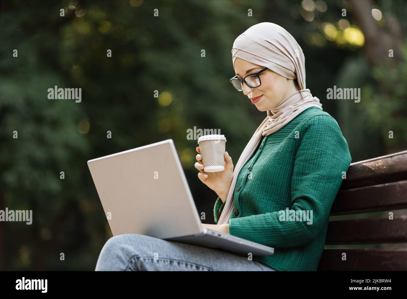 Attractive muslim business woman drinking coffee while having break ...