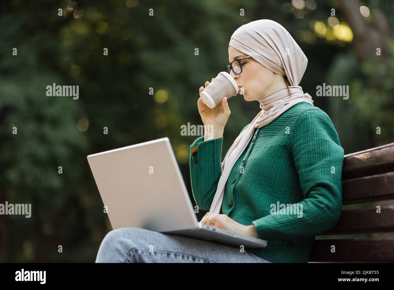 Happy smiling muslim business woman drinking coffee on a break sitting ...