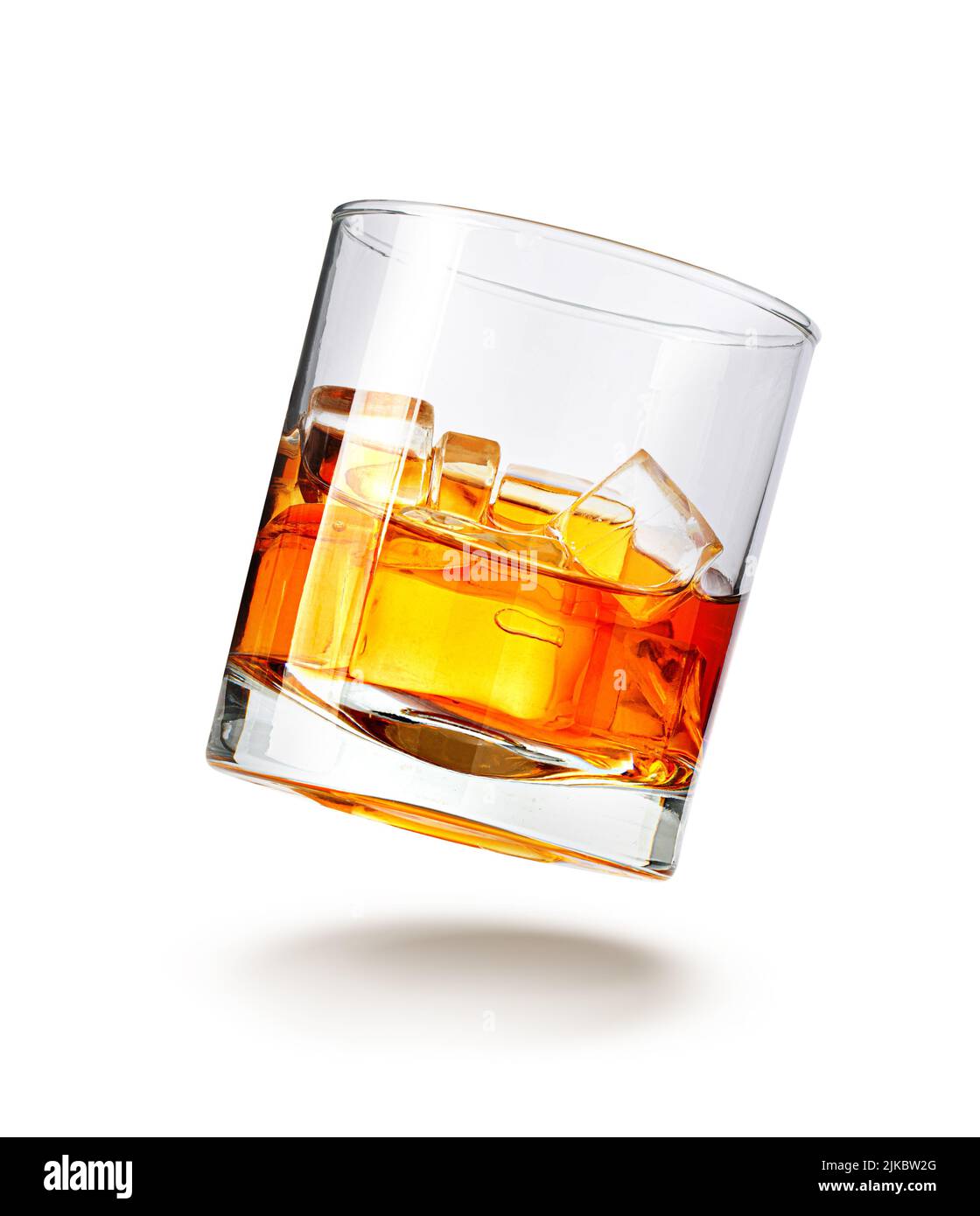 A glass of whiskey and ice on a white background with clipping path