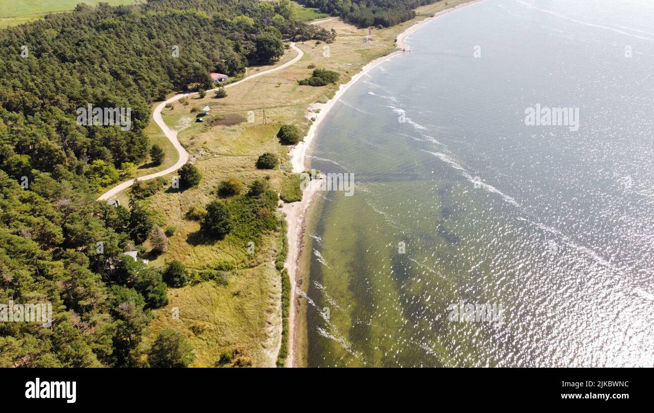 An aerial view of a sea surrounded by green forest Stock Photo - Alamy