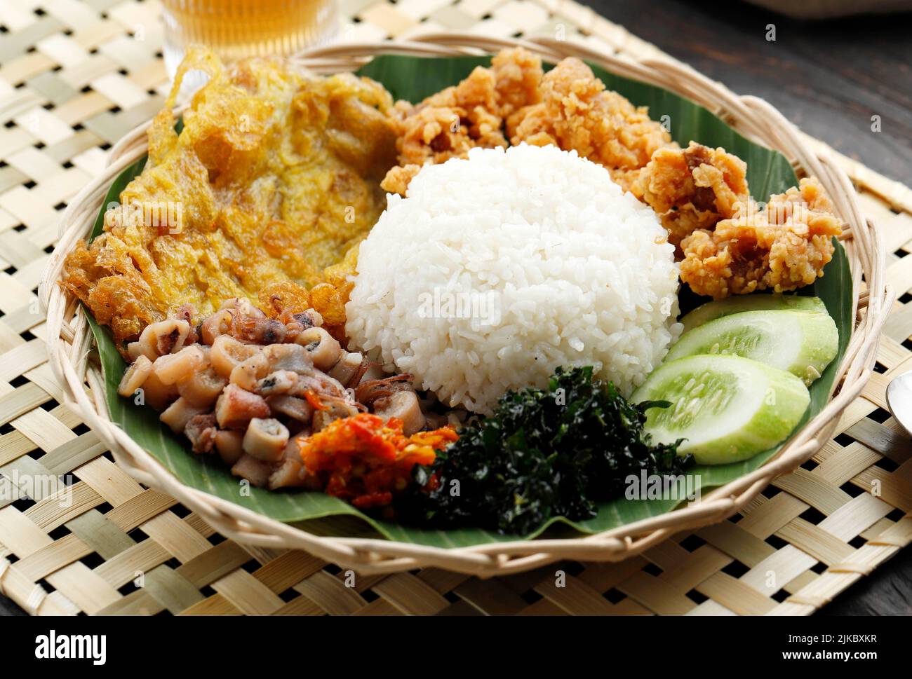 Nasi Campur Bali. Popular Balinese Street Food Meal of Rice with Variety Side Dishes. Selected Focus Stock Photo